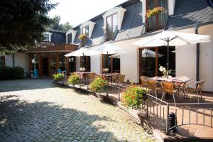 a restaurant with tables and chairs and umbrellas at Hotel Rezydencja Solei in Poznań