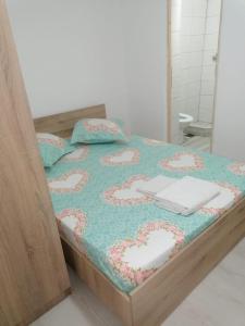 a bedroom with a bed with a laptop on it at Emyra's holiday rooms in Constanţa