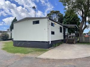 a small white building with a porch on a driveway at BIG4 Toowoomba Garden City Holiday Park in Toowoomba