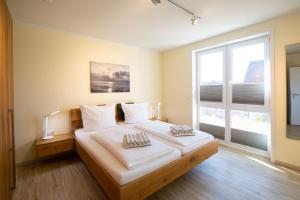 Postel nebo postele na pokoji v ubytování Weiße Düne Ferienwohnung *Weiße Düne 6*