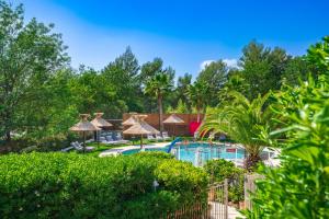 a resort with a swimming pool and trees at Les Bastides Saint Paul in Saint Paul de Vence
