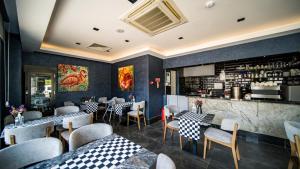 a restaurant with tables and chairs and a bar at Sea Palm Otel Yalıkavak in Yalıkavak