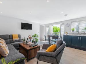 a living room with a couch and a table at The Apartment at Solley Farm House in Deal