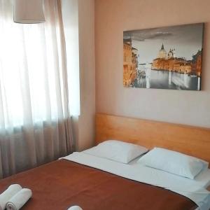 a bedroom with a bed with a picture on the wall at Sun City View in Thessaloniki