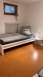 a bed sitting in a room with a window at Apartment near Europa-Park & Black Forest in Kappel-Grafenhausen