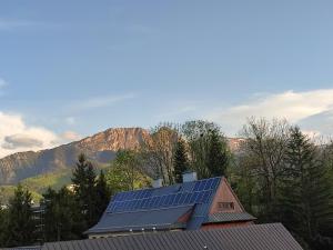 a house with solar panels on the roof of it at Retrospekcja - Apartament w centrum in Zakopane