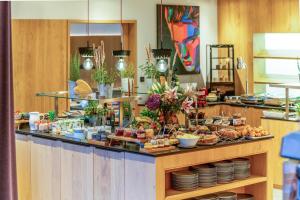 a buffet with a lot of food on a table at Wellness und Brunch Hotel MorgenZeit beheizter Naturpool mit Sandstrand Genuss Frühstück bis 13 Uhr Hochkönig Sommercard in Maria Alm am Steinernen Meer