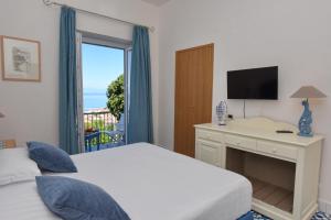 Postel nebo postele na pokoji v ubytování Hotel Garden Riviera