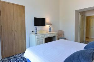 Postel nebo postele na pokoji v ubytování Hotel Garden Riviera
