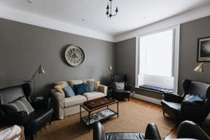 a living room with a couch and chairs and a window at DUNDAS COTTAGE - Beautiful Spacious 3 Bed Cottage in Richmond, North Yorkshire in Richmond