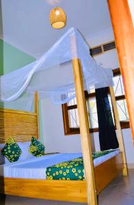 a bunk bed with a canopy in a room at Buutu Nest in Jinja
