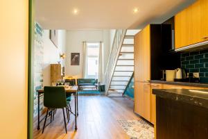 a kitchen and dining room with a table and chairs at "L' Atelier de la Tour" - Centre Ville - Confort - Cosy -Relax in Dijon