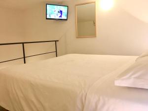 a bedroom with a bed and a tv on the wall at Casa Mafalda B&B in Lipari