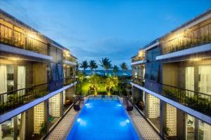 a view of a swimming pool between two buildings at Sea Lavie Boutique Resort & Spa in Hoi An