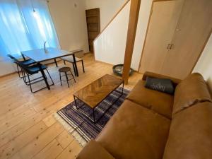 a living room with a couch and a table at FamA in Nakafurano