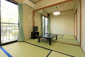 a room with a ping pong table in front of a window at Ocean View Hamayu in Makinohara