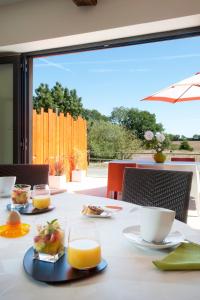 a table with food and drinks on top of it at La Villa des Forges in Legé