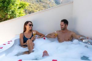 a man and a woman sitting in a bathtub with champagne at Sundia By Liberty Oludeniz in Oludeniz