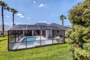 a home with a pool in a gazebo at NEW Modern Relaxing 4 Bedroom Pool Villa Near Disney's Parks in Davenport