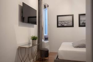 En eller flere senge i et værelse på San Niccolò Luxury Apartment