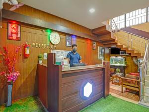 a man standing at the counter of a restaurant at Marhaba tourist home in Kozhikode