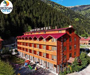 a rendering of a hotel with mountains in the background at Sezgin Hotel in Uzungol