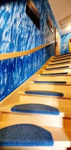 a row of stairs in a church with a blue wall at Caroline & Maurice in Ostseebad Koserow