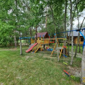 a park with a playground with a slide at Domki Wzgórze Kamień in Józefów