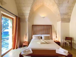 Voodi või voodid majutusasutuse Masseria La Millenaria toas