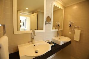 a bathroom with a white sink and a mirror at Orange County Belek in Belek