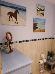 a bathroom with a horse painting on the wall at Carlingford Mountain and Sea Views in Carlingford
