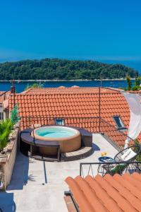 an outdoor patio with a swimming pool and chairs at Villa Lizza in Cavtat