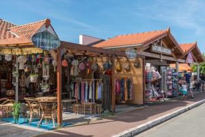 a store with a table and chairs in front of it at Charmante maison au cœur du medoc in Cussac-Fort-Medoc