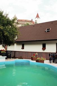 a large swimming pool in front of a house at Penzion v Budech in Křivoklát