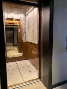 a glass door of a bathroom with a mirror at My G yoo Apartment #2 in Istanbul
