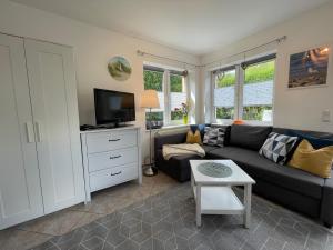a living room with a couch and a tv at Ferienwohnungen Göhren in Göhren