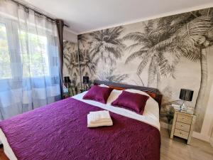a bedroom with a purple bed with purple pillows at Cannes Appartement Palais Festivals in Cannes