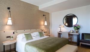 a hotel room with two beds and a mirror at Starhotels Metropole in Rome
