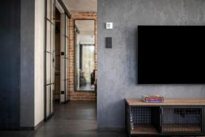 a living room with a television on a wall at Easy Rent Apartments - City Rest, Basen & SPA, Centrum Free Parking 24h Check-in in Lublin