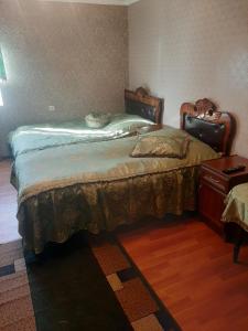 a bedroom with two beds and a dresser at NarVar Hotel in Goris