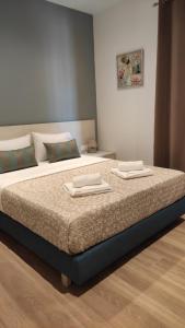 a bedroom with a bed with two towels on it at Soula Apartments & Studios in Palaiochora