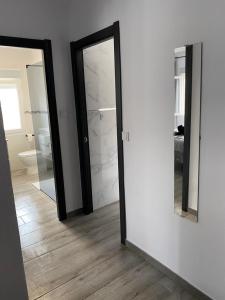 a bathroom with two mirrors and a white wall at NUEVO!!! PISO CENTRICO EN SUANCES -Sol Luxury- in Suances