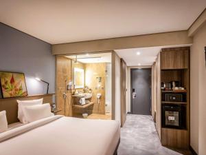 Cama ou camas em um quarto em Novotel BH Savassi