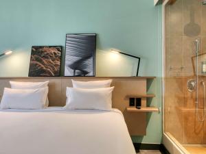 Cama ou camas em um quarto em Novotel BH Savassi
