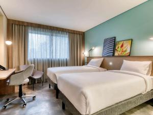 Cama ou camas em um quarto em Novotel BH Savassi