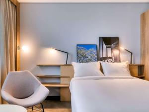 Cama ou camas em um quarto em Novotel BH Savassi