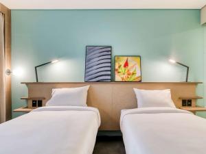 Cama ou camas em um quarto em Novotel BH Savassi