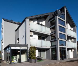 an office building with a black and white facade at Domki i Apartamenty Al Mare in Sianozety