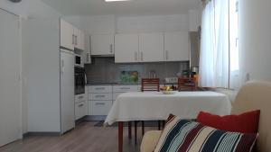 a kitchen with a table with a white table cloth at StaynFeel 01 in Fátima