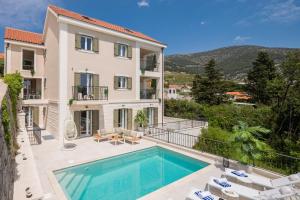 an exterior view of a house with a swimming pool at Villa Mirta in Bol